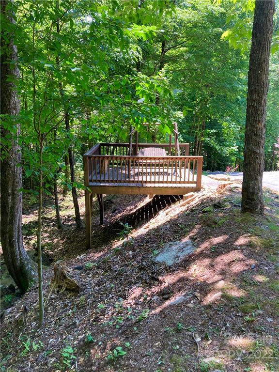 160 Flying Hawk Road Waynesville, NC 28786 - Photo 13 of 45 a view of a street with a bench of trees