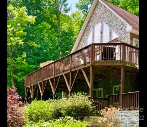 160 Flying Hawk Road Waynesville, NC 28786 - Photo 17 of 45 a view of a wooden house with a yard