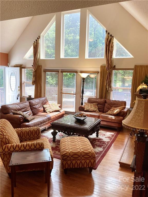 160 Flying Hawk Road Waynesville, NC 28786 - Photo 3 of 45 a living room with furniture wooden floor and a large window
