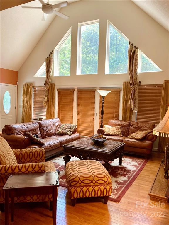 160 Flying Hawk Road Waynesville, NC 28786 - Photo 34 of 45 a living room with furniture and floor to ceiling windows
