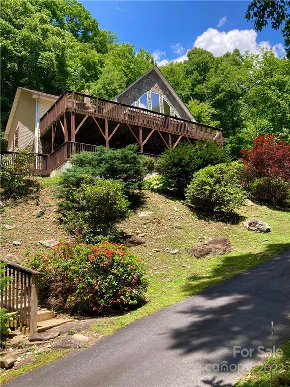 160 Flying Hawk Road Waynesville, NC 28786 - Photo 35 of 45 a house with green field in front of it