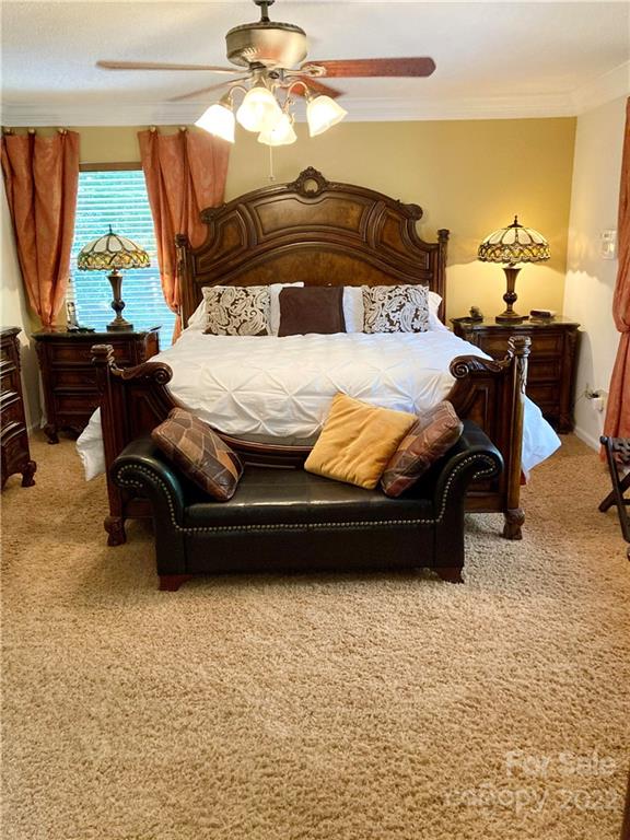 160 Flying Hawk Road Waynesville, NC 28786 - Photo 8 of 45 a bedroom with a bed and a chandelier