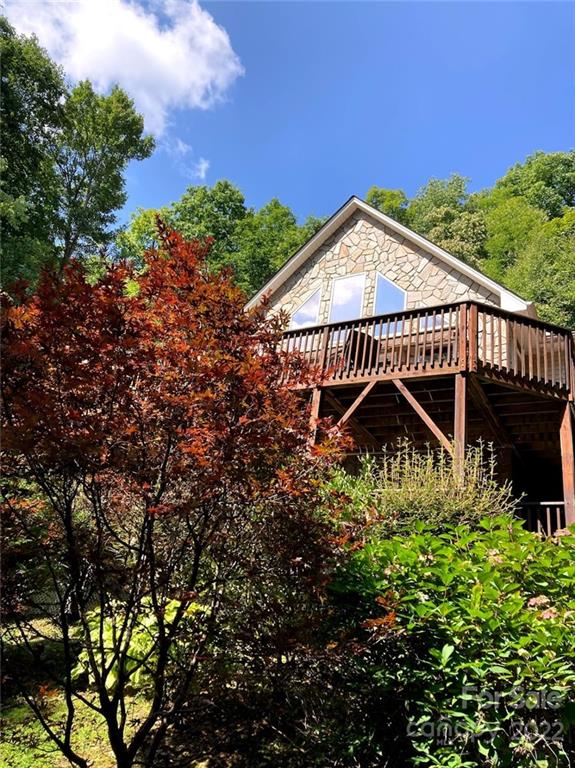 160 Flying Hawk Road Waynesville, NC 28786 - Photo 10 of 45 a view of a swimming pool with a patio and a garden