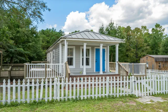 a front view of a house with a garden
