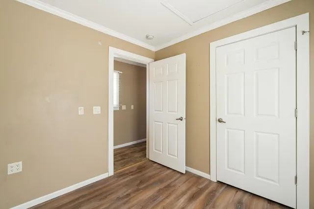 an empty room with wooden floor and closet