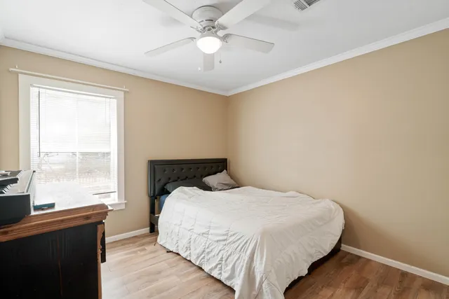 a bedroom with a bed and a window