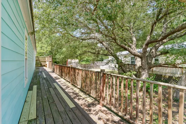 a view of balcony with wooden floor and fence