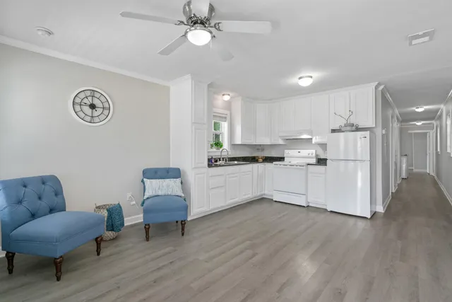 a living room with kitchen island furniture and a kitchen view