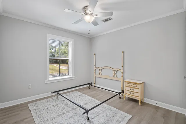 a living room with hard wood floor and a table