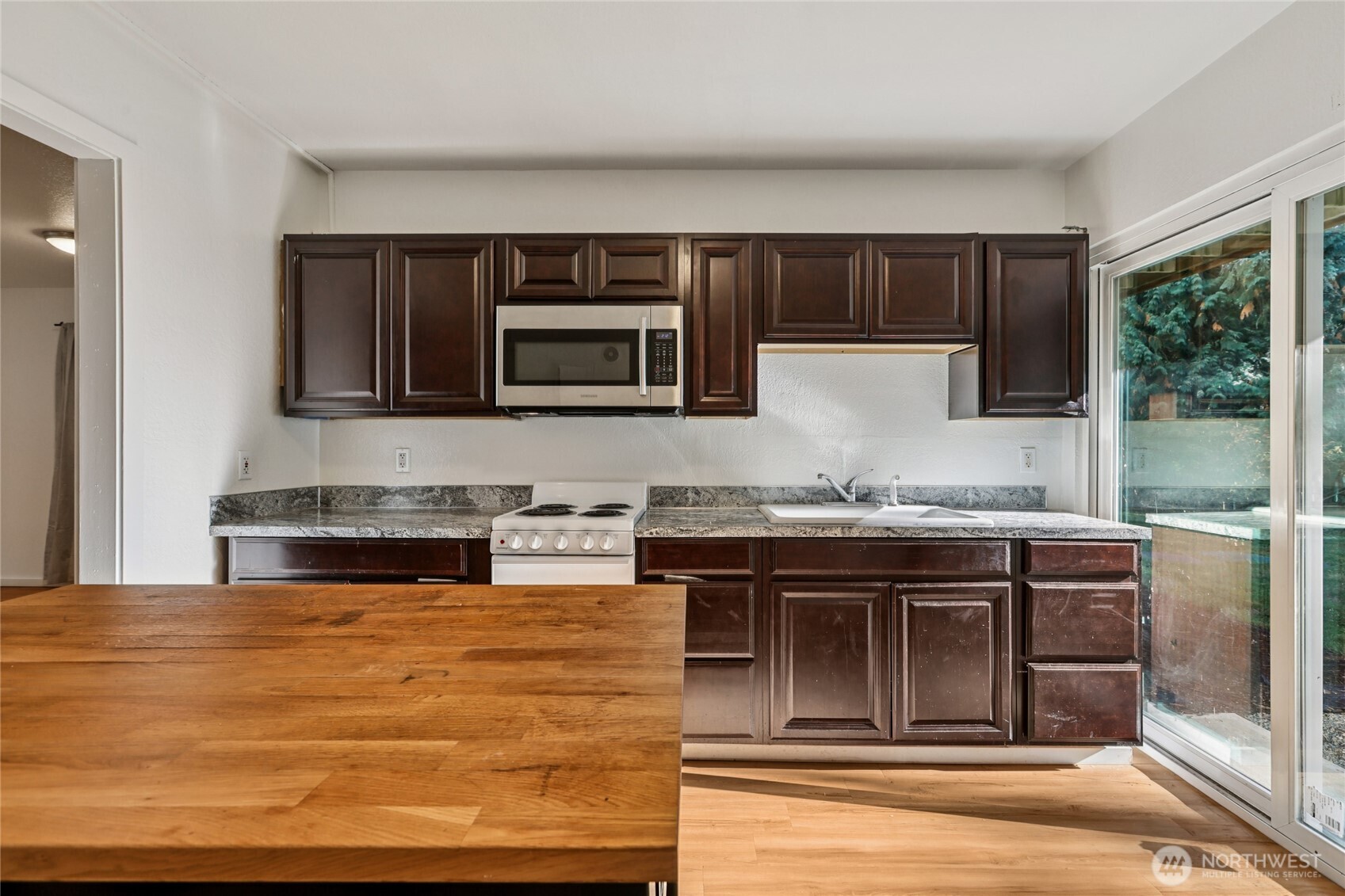 8032 71st Place Southeast Snohomish, WA 98290 - Photo 21 of 32 a kitchen with stainless steel appliances granite countertop a stove and a microwave