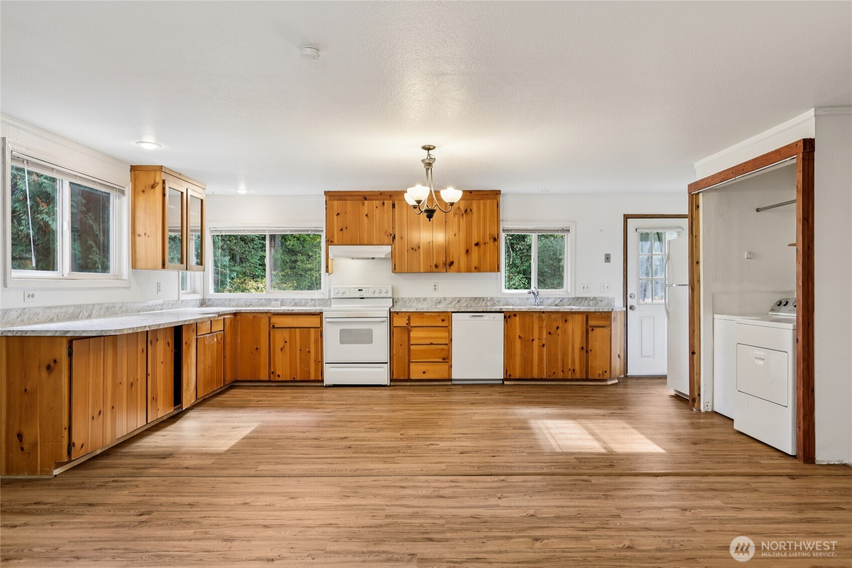 8032 71st Place Southeast Snohomish, WA 98290 - Photo 7 of 32 a large kitchen with stainless steel appliances granite countertop a large counter top a sink and a refrigerator