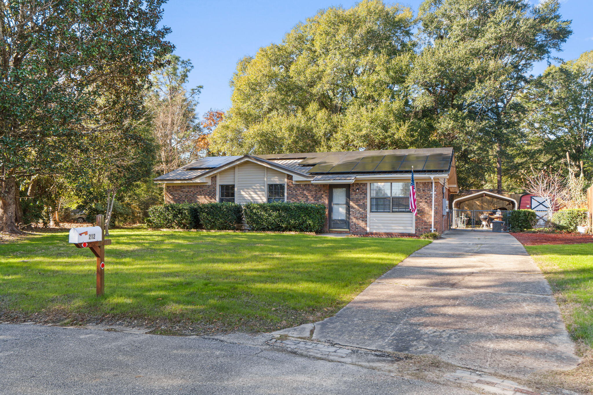 212 Aza Place Crestview, FL 32539 - Photo 1 of 30 a front view of a house with a yard