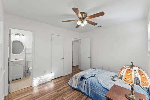 a bedroom with a bed and wooden floor