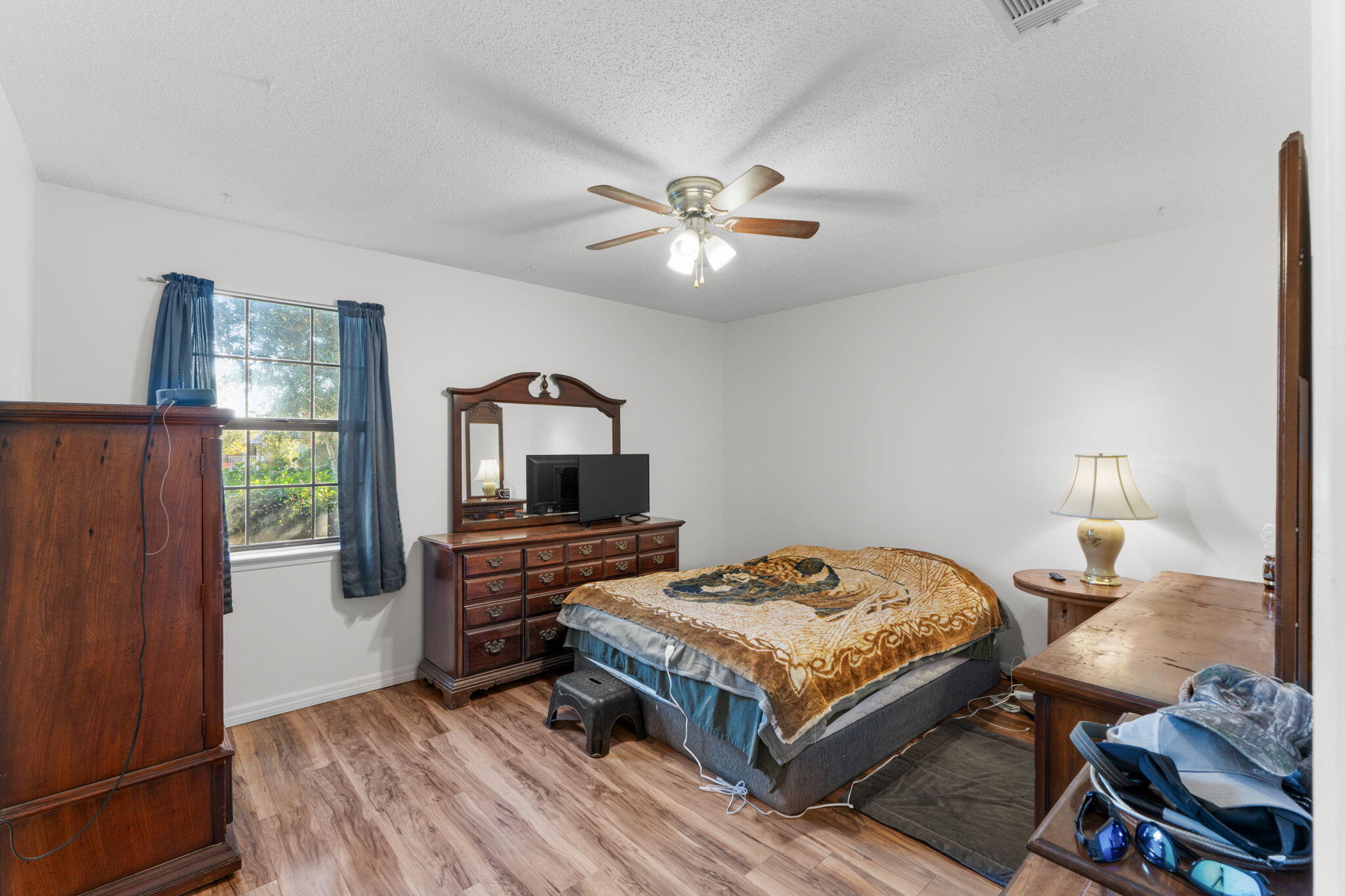 212 Aza Place Crestview, FL 32539 - Photo 15 of 30 a bedroom with a bed and a chandelier