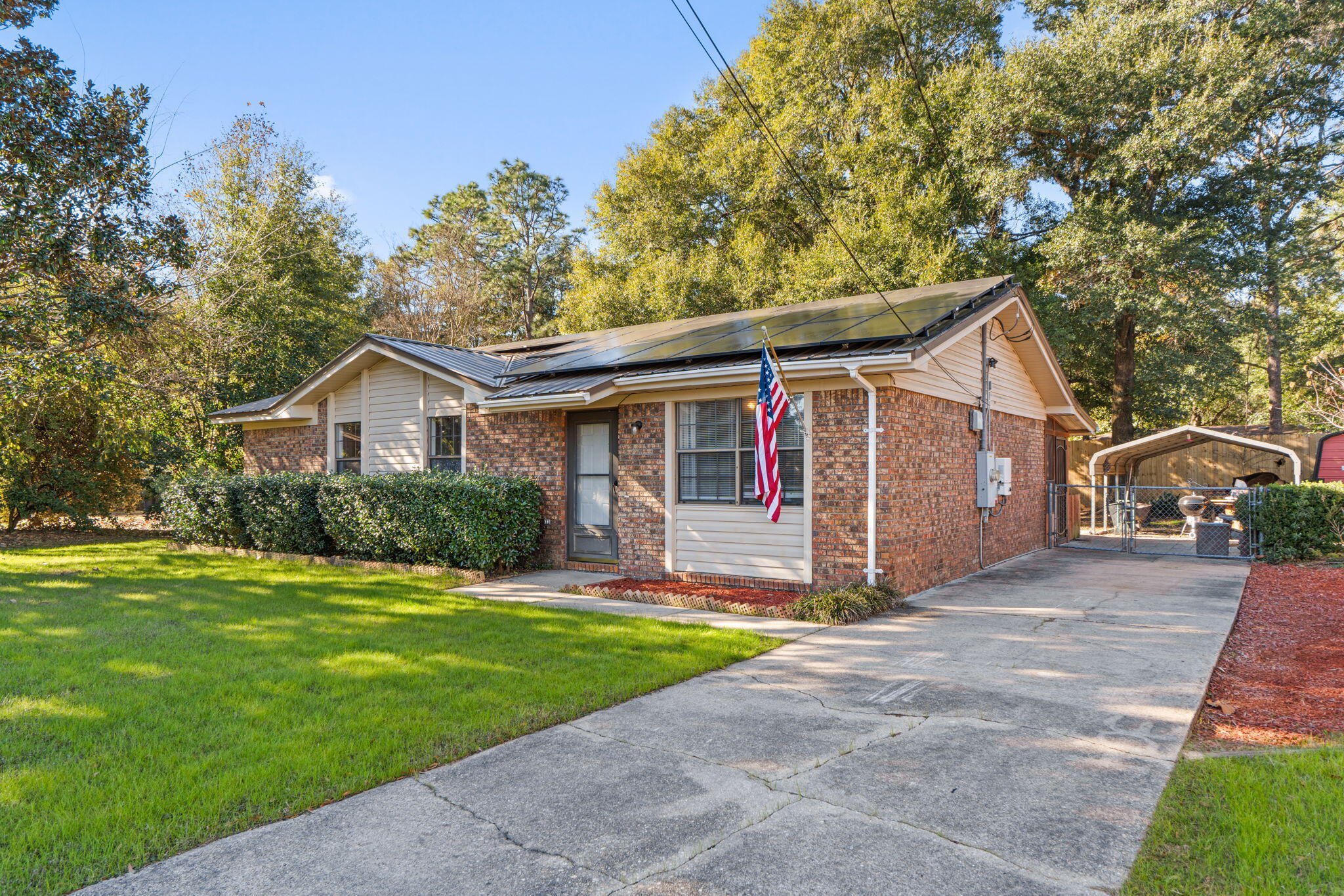 212 Aza Place Crestview, FL 32539 - Photo 2 of 30 a front view of a house with a yard and garage