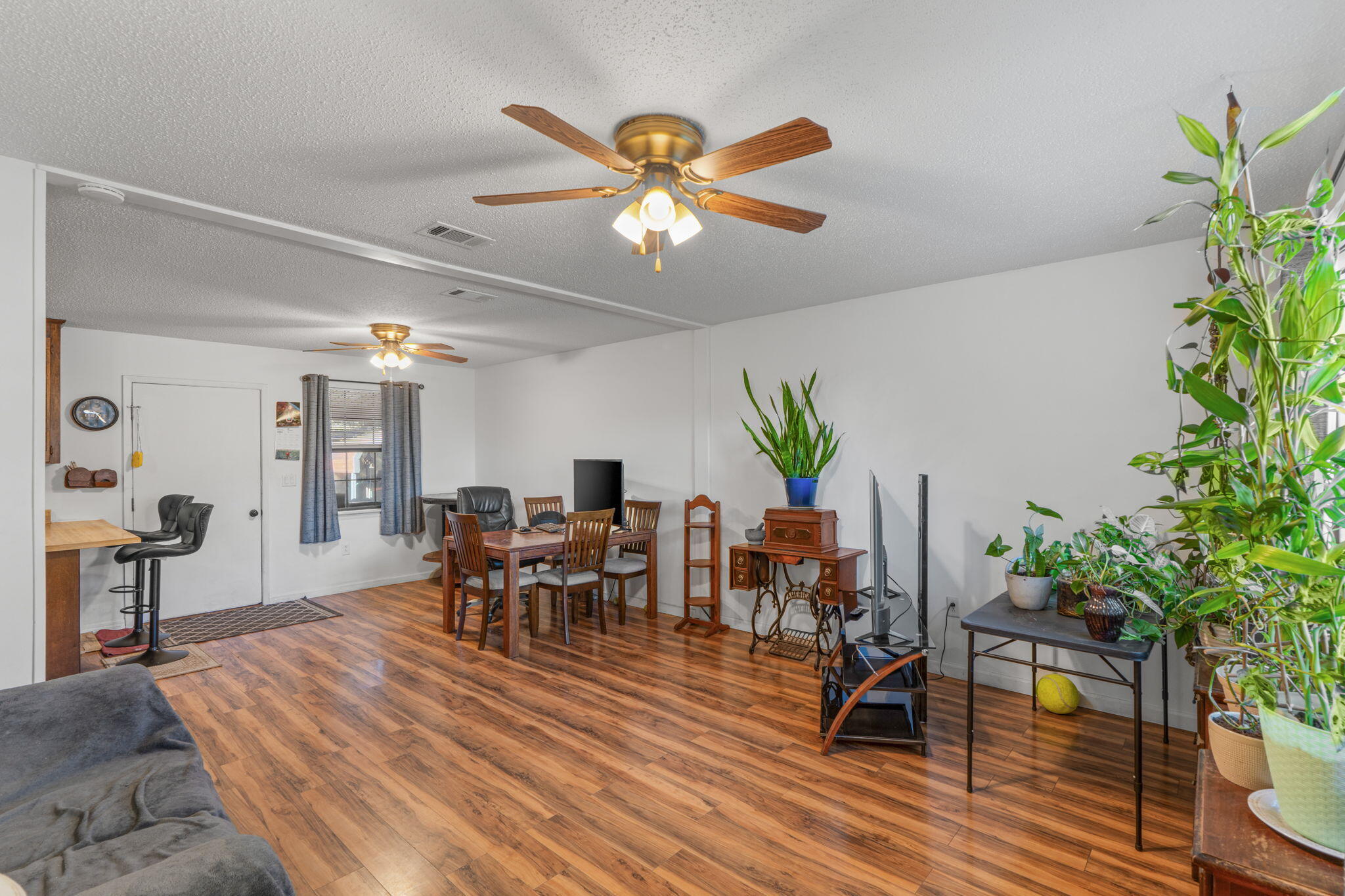 212 Aza Place Crestview, FL 32539 - Photo 4 of 30 a dining room with furniture potted plants and wooden floor