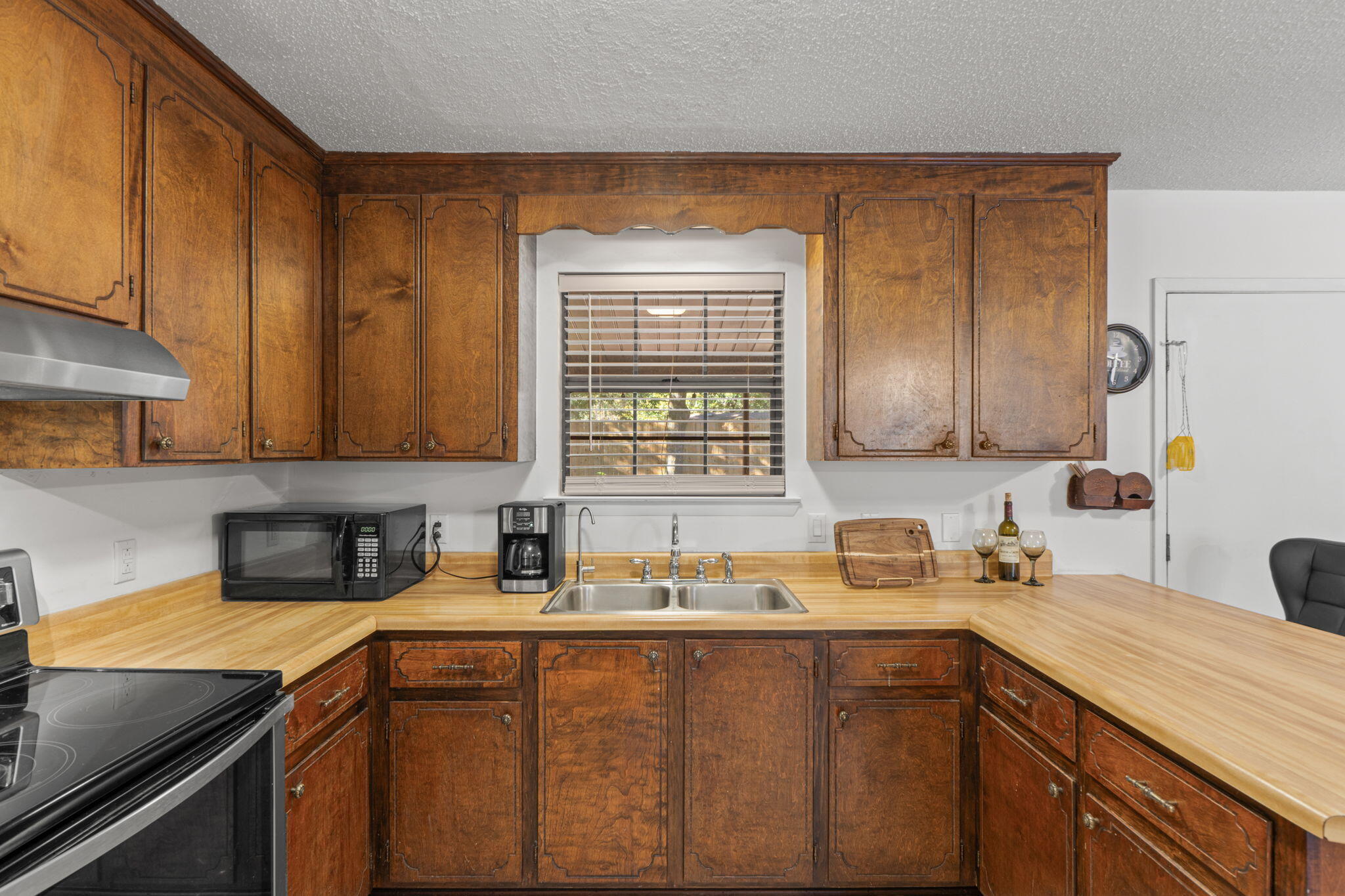 212 Aza Place Crestview, FL 32539 - Photo 8 of 30 a kitchen with a sink a stove cabinets and a window