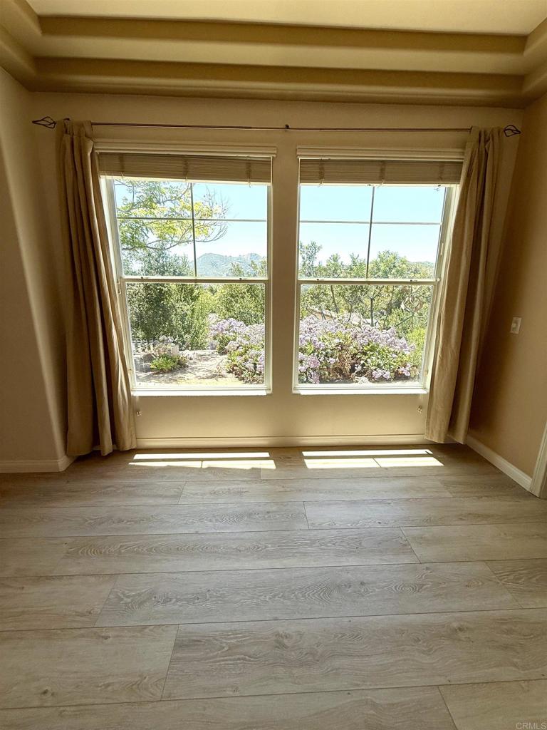2527 Southern Oak Road Ramona, CA 92065 - Photo 52 of 56 a view of an empty room with wooden floor and a window