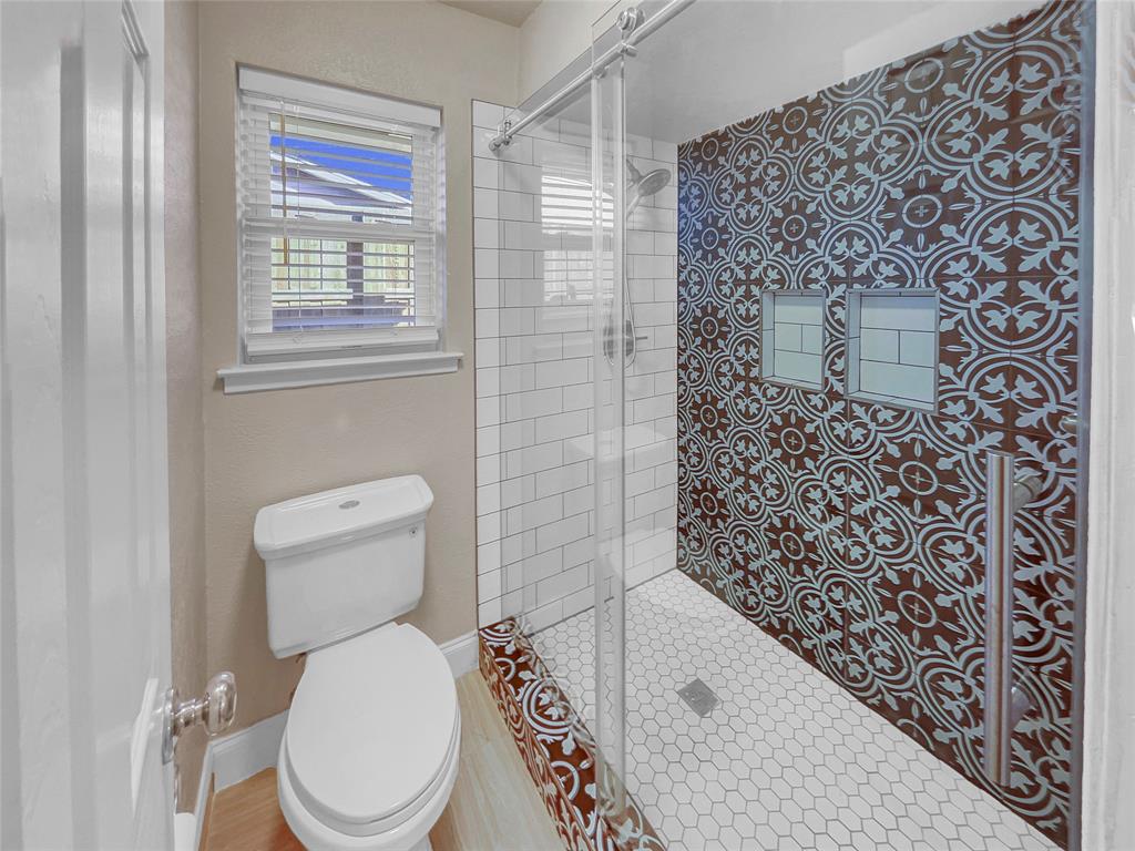 1736 Reynoldston Lane Dallas, TX 75232 - Photo 11 of 17 a white toilet sitting next to a bathroom sink