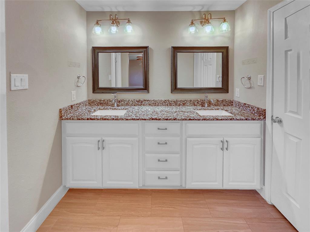 1736 Reynoldston Lane Dallas, TX 75232 - Photo 13 of 17 a bathroom with a granite countertop double vanity sink and mirror