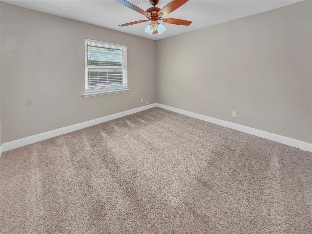 1736 Reynoldston Lane Dallas, TX 75232 - Photo 14 of 17 an empty room with a window and a fan