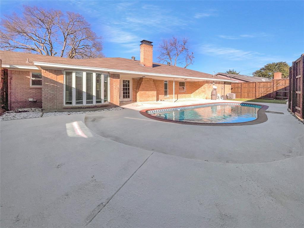 1736 Reynoldston Lane Dallas, TX 75232 - Photo 16 of 17 a front view of a house with a yard