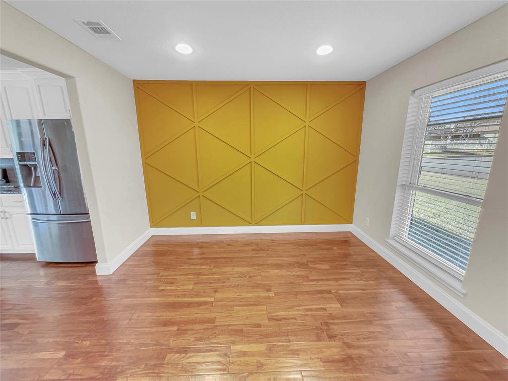 1736 Reynoldston Lane Dallas, TX 75232 - Photo 3 of 17 a view of a room with wooden floor and a window