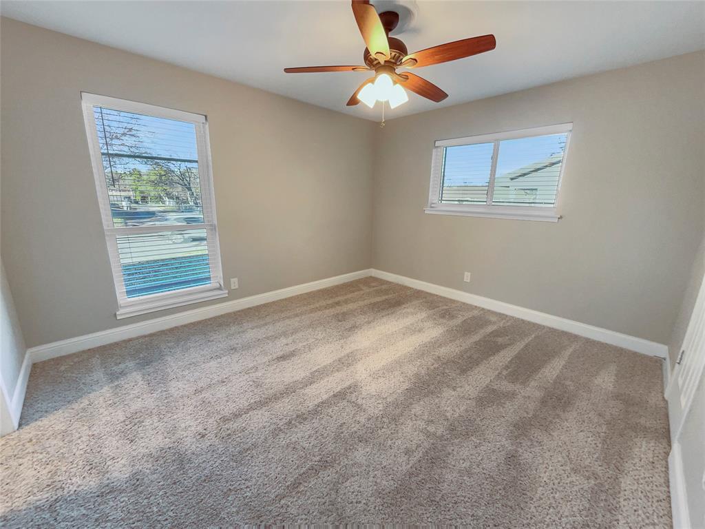 1736 Reynoldston Lane Dallas, TX 75232 - Photo 5 of 17 a view of an empty room with a window