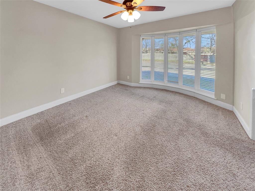 1736 Reynoldston Lane Dallas, TX 75232 - Photo 6 of 17 a view of an empty room with a window
