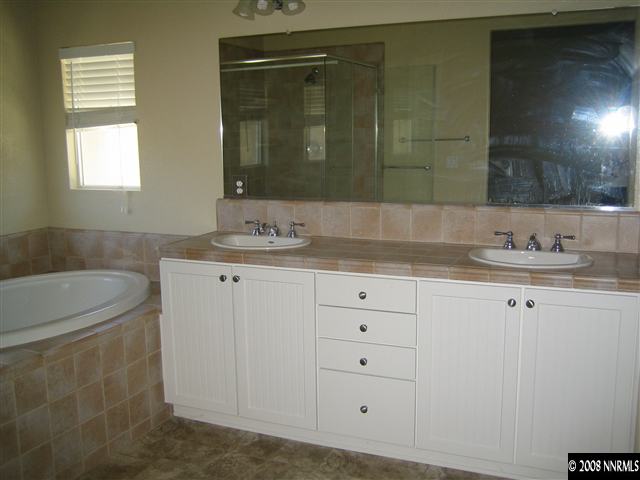 3270 Paragon Place Reno, NV 89509 - Photo 6 of 9 a bathroom with a sink and a mirror