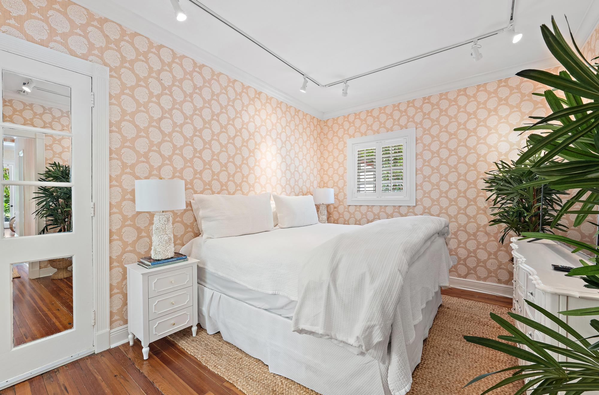 151 South County Road, Unit 1 Palm Beach, FL 33480 - Photo 7 of 18 a bed room with a bed and a potted plant