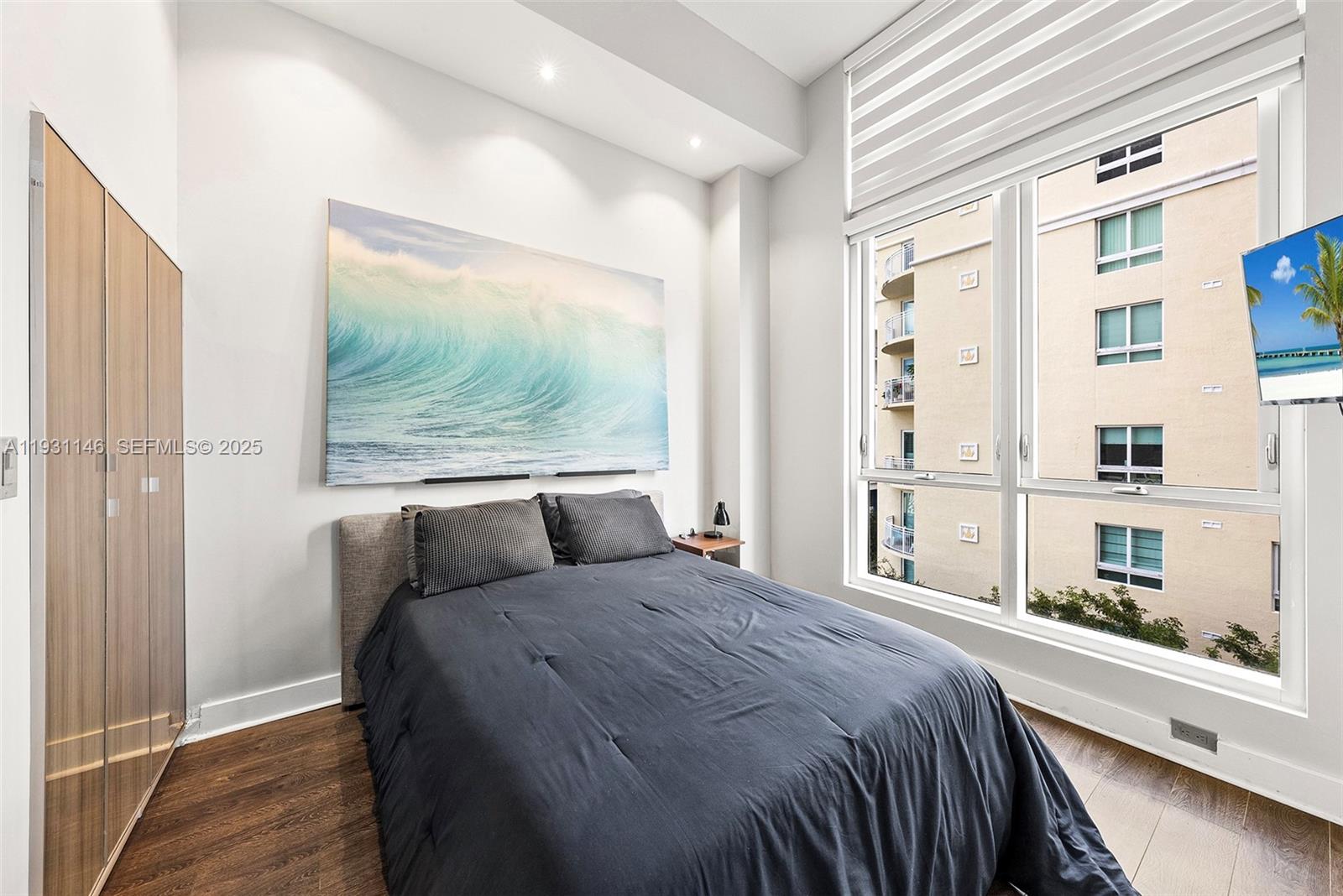 9066 Southwest 73rd Court, Unit 405 Miami, FL 33156 - Photo 11 of 32 a bedroom with a large bed and a window