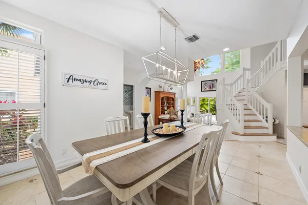 a dining room with furniture and a chandelier