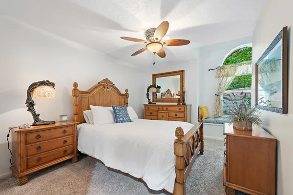 a bedroom with a bed and a chandelier