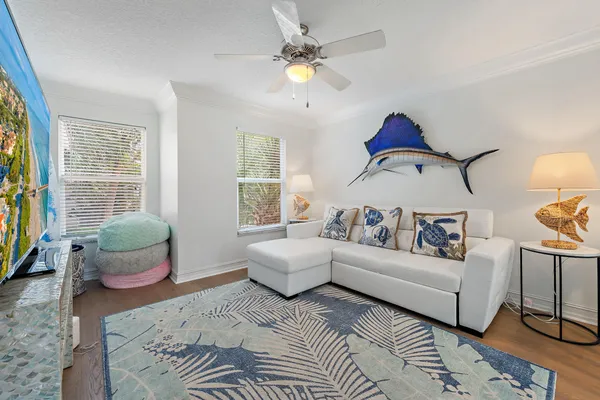 a living room with furniture a chandelier and a window