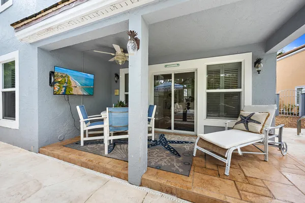 a outdoor living space with furniture and a flat screen tv
