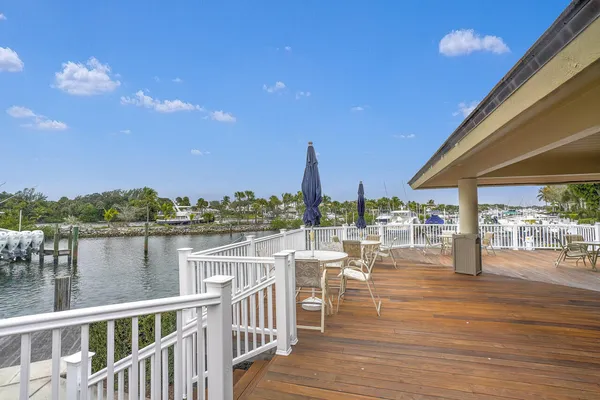 a view of a lake from a balcony with furniture