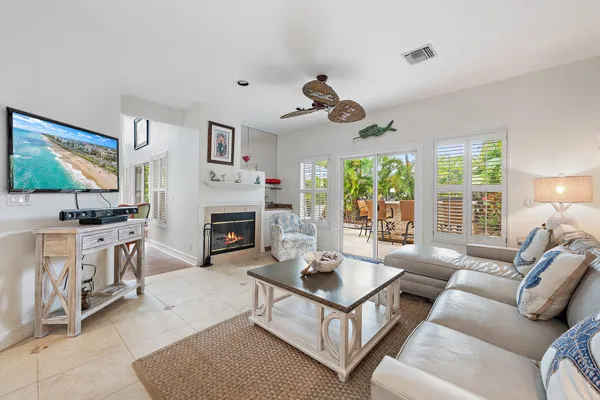 a living room with furniture a fireplace and a flat screen tv