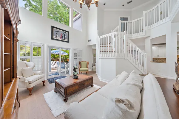 a living room with furniture and a table with wooden floor