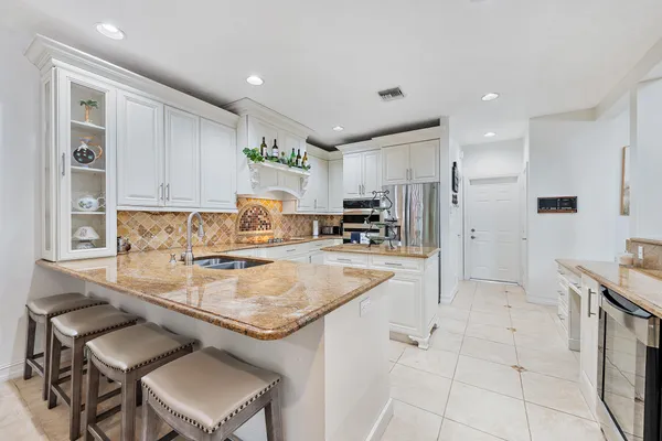a kitchen with stainless steel appliances granite countertop a sink and cabinets