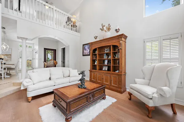 a living room with furniture a rug and a window