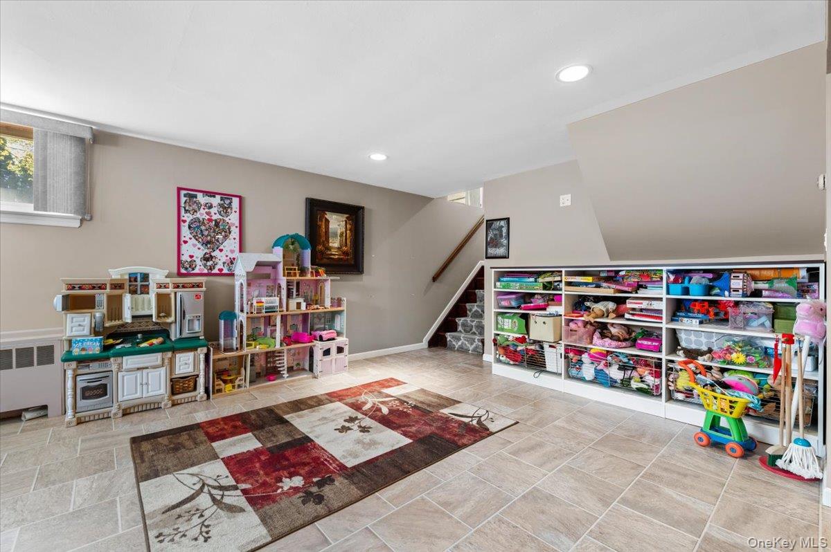 61 Winthrop Road Plainview, NY 11803 - Photo 27 of 37 a living room with lots of baby furniture and toys
