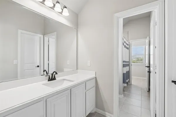 a bathroom with a double vanity sink mirror and shower