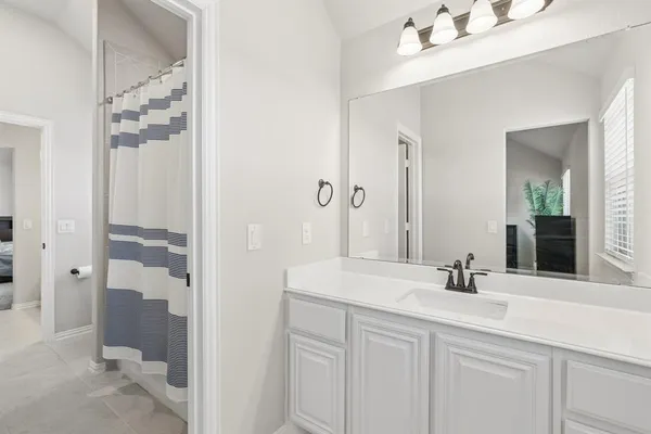 a bedroom with a bed and ceiling fan