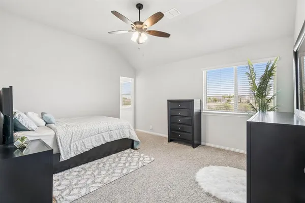 a bedroom with furniture and a flat screen tv