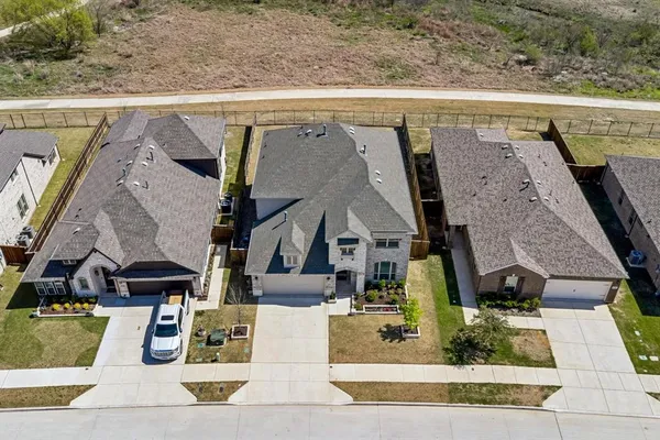 an aerial view of residential houses with outdoor space