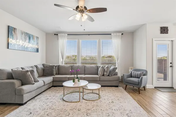 a living room with furniture and a large window