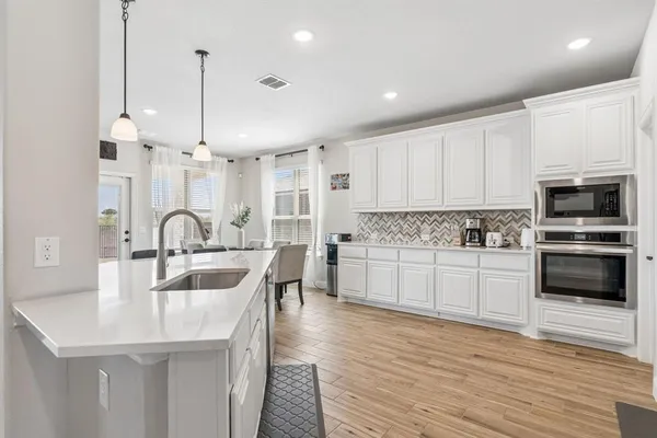 a kitchen with counter top space cabinets and appliances