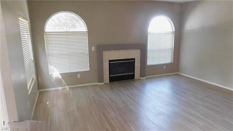 1623 Cave Spring Drive Henderson, NV 89014 - Photo 2 of 16 Natural light pours into this living space, highlighting the contemporary fireplace and light wood-look flooring.