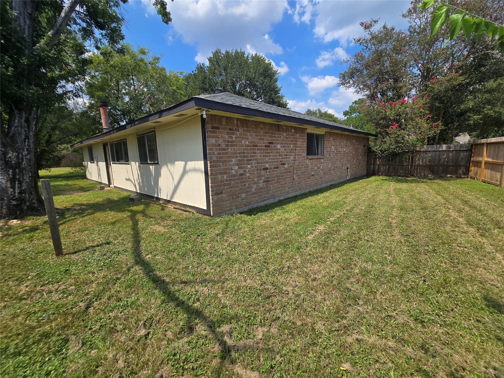16331 Dew Drop Lane Houston, TX 77095 - Photo 16 of 20 a view of backyard with wooden fence and large trees